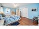 Spacious main bedroom featuring hardwood floors, coastal decor, and ensuite bathroom access at 5733 Pawnee St, Zephyrhills, FL 33542
