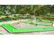 A fun mini golf course winds through mature trees, colorful obstacles, and charming decorations for Gathering entertainment at 5733 Pawnee St, Zephyrhills, FL 33542