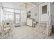 Bright patio with tiled floor, seating area, and multiple access points to the outdoors at 5733 Pawnee St, Zephyrhills, FL 33542