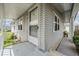 Inviting front porch with white railings and siding creates a welcoming entry to the home at 5733 Pawnee St, Zephyrhills, FL 33542