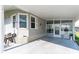 Covered entryway with two wicker chairs, providing a shaded seating area at 5733 Pawnee St, Zephyrhills, FL 33542