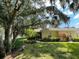 House exterior with lush landscaping and trees at 1178 Green Oak Trl, Port Charlotte, FL 33948
