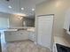Kitchen features white cabinets, tile flooring, and a dishwasher at 1178 Green Oak Trl, Port Charlotte, FL 33948