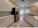Modern kitchen with stainless steel refrigerator and white cabinets at 1178 Green Oak Trl, Port Charlotte, FL 33948
