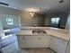 View of kitchen and adjoining living area with tile and carpet flooring at 1178 Green Oak Trl, Port Charlotte, FL 33948