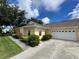 House exterior with a two car garage and walkway at 1178 Green Oak Trl, Port Charlotte, FL 33948
