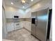 White kitchen cabinets and stainless steel appliances at 1178 Green Oak Trl, Port Charlotte, FL 33948