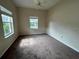 Well-lit bedroom with carpet flooring and two windows at 1178 Green Oak Trl, Port Charlotte, FL 33948
