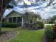 Single-story home with screened porch and manicured lawn at 1178 Green Oak Trl, Port Charlotte, FL 33948