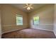 Well-lit bedroom with carpet flooring and two windows at 1178 Green Oak Trl, Port Charlotte, FL 33948
