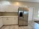 Kitchen area with stainless steel refrigerator and white cabinets at 1178 Green Oak Trl, Port Charlotte, FL 33948