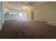 Bright living room featuring carpet flooring and a ceiling fan at 1178 Green Oak Trl, Port Charlotte, FL 33948