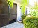 Screened entryway with a paved floor and lush greenery at 2501 Lonigan Pl, Sun City Center, FL 33573