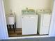 Interior laundry room with washer, dryer, and utility sink at 2501 Lonigan Pl, Sun City Center, FL 33573