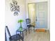 Front entry with tiled flooring, seating area, and decorative wall art at 2501 Lonigan Pl, Sun City Center, FL 33573