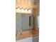 Double vanity bathroom with updated light fixtures at 6009 Sea Ranch Dr # 705, Hudson, FL 34667
