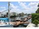 Boats docked at a marina with waterfront homes visible in the background at 6009 Sea Ranch Dr # 705, Hudson, FL 34667