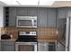 Kitchen with stainless steel appliances and gray cabinets at 6009 Sea Ranch Dr # 705, Hudson, FL 34667