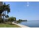 Calm water view with palm trees and a walkway at 6009 Sea Ranch Dr # 705, Hudson, FL 34667