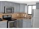 Updated kitchen, stainless steel appliances, gray cabinets at 6009 Sea Ranch Dr # 705, Hudson, FL 34667