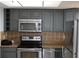 Kitchen with stainless steel appliances and gray cabinets at 6009 Sea Ranch Dr # 705, Hudson, FL 34667