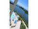 Inviting condo pool area with ample lounge chairs and tranquil water views at 6009 Sea Ranch Dr # 705, Hudson, FL 34667