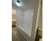 Clean bathroom with a bathtub, tiled walls, and light gray flooring at 14105 Mossy Glen Ln # 202, Tampa, FL 33613