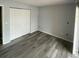 Spacious bedroom with gray walls, wood-look flooring and a large closet at 14105 Mossy Glen Ln # 202, Tampa, FL 33613