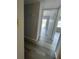 Bright hallway with light gray vinyl plank flooring leading to other rooms at 14105 Mossy Glen Ln # 202, Tampa, FL 33613