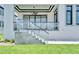 Covered patio with glass railings, modern ceiling fan, and access to the backyard at 517 Treviso Dr, Apollo Beach, FL 33572