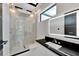 Modern bathroom with frameless glass shower, floating vanity, and LED mirror at 517 Treviso Dr, Apollo Beach, FL 33572