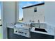 High-end outdoor grill with marble countertops and sink at 517 Treviso Dr, Apollo Beach, FL 33572