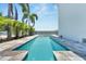 Long, refreshing swimming pool with a built-in spa and mosaic tile accents at 517 Treviso Dr, Apollo Beach, FL 33572