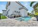 Modern pool and spa with gray stone patio and outdoor kitchen at 517 Treviso Dr, Apollo Beach, FL 33572