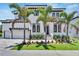 Two-story home with white exterior, dark trim, and palm trees at 517 Treviso Dr, Apollo Beach, FL 33572