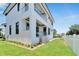 Modern two-story house with a white exterior, black window frames, and a manicured lawn at 517 Treviso Dr, Apollo Beach, FL 33572