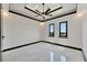 Well-lit bedroom featuring marble floors and ceiling fan at 517 Treviso Dr, Apollo Beach, FL 33572