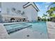 Relaxing pool and spa with gray stone patio and outdoor kitchen area at 517 Treviso Dr, Apollo Beach, FL 33572