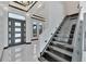 Modern black granite staircase with glass railing and LED lighting at 517 Treviso Dr, Apollo Beach, FL 33572