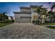 Two story house with a large driveway and landscaping at 517 Treviso Dr, Apollo Beach, FL 33572