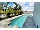 Luxury pool and spa with gray stone decking at 517 Treviso Dr, Apollo Beach, FL 33572