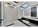 Modern bathroom with frameless glass shower, floating vanity, and LED mirror at 517 Treviso Dr, Apollo Beach, FL 33572