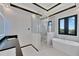 Luxurious bathroom with soaking tub, glass shower, and marble floors at 517 Treviso Dr, Apollo Beach, FL 33572