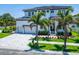 Two-story home with white exterior, gray driveway, and landscaping at 517 Treviso Dr, Apollo Beach, FL 33572