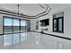 Luxury living room with marble floors, fireplace and large windows at 517 Treviso Dr, Apollo Beach, FL 33572