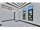 Open living room with marble floors and large windows at 517 Treviso Dr, Apollo Beach, FL 33572