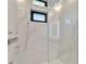 Elegant marble shower with frameless glass enclosure at 517 Treviso Dr, Apollo Beach, FL 33572