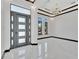 Bright entryway with marble floors and modern chandelier at 517 Treviso Dr, Apollo Beach, FL 33572