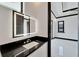 Modern bathroom with black countertop and LED mirror at 517 Treviso Dr, Apollo Beach, FL 33572