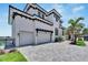Two-story home with white exterior, double garage, and landscaping at 517 Treviso Dr, Apollo Beach, FL 33572